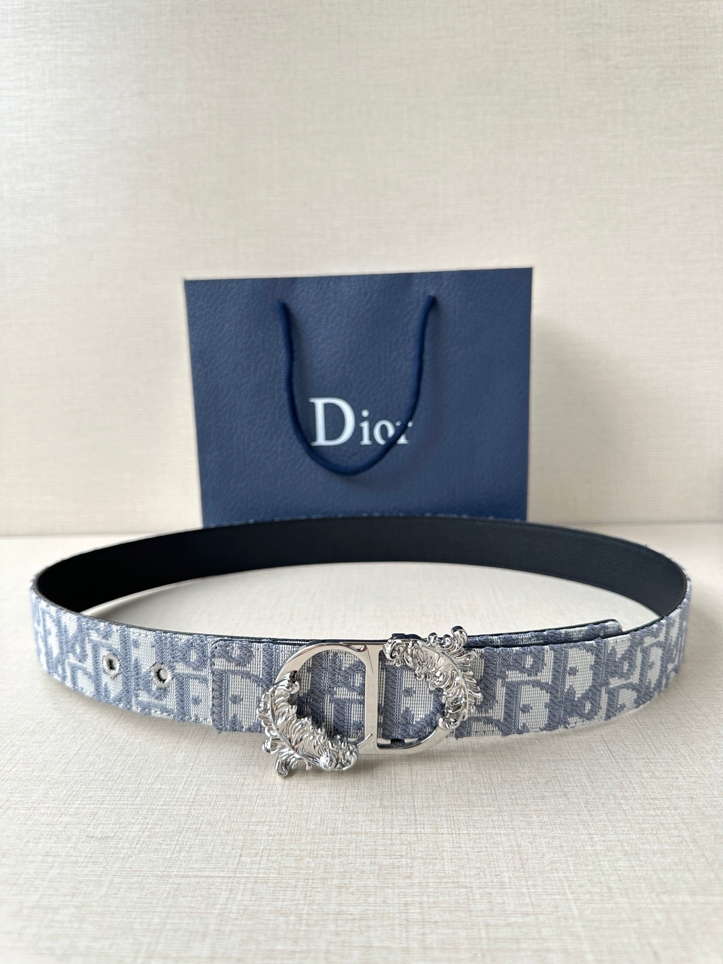 Dior belt: blue-gray logo jacquard strap with ornate silver buckle and gold detail