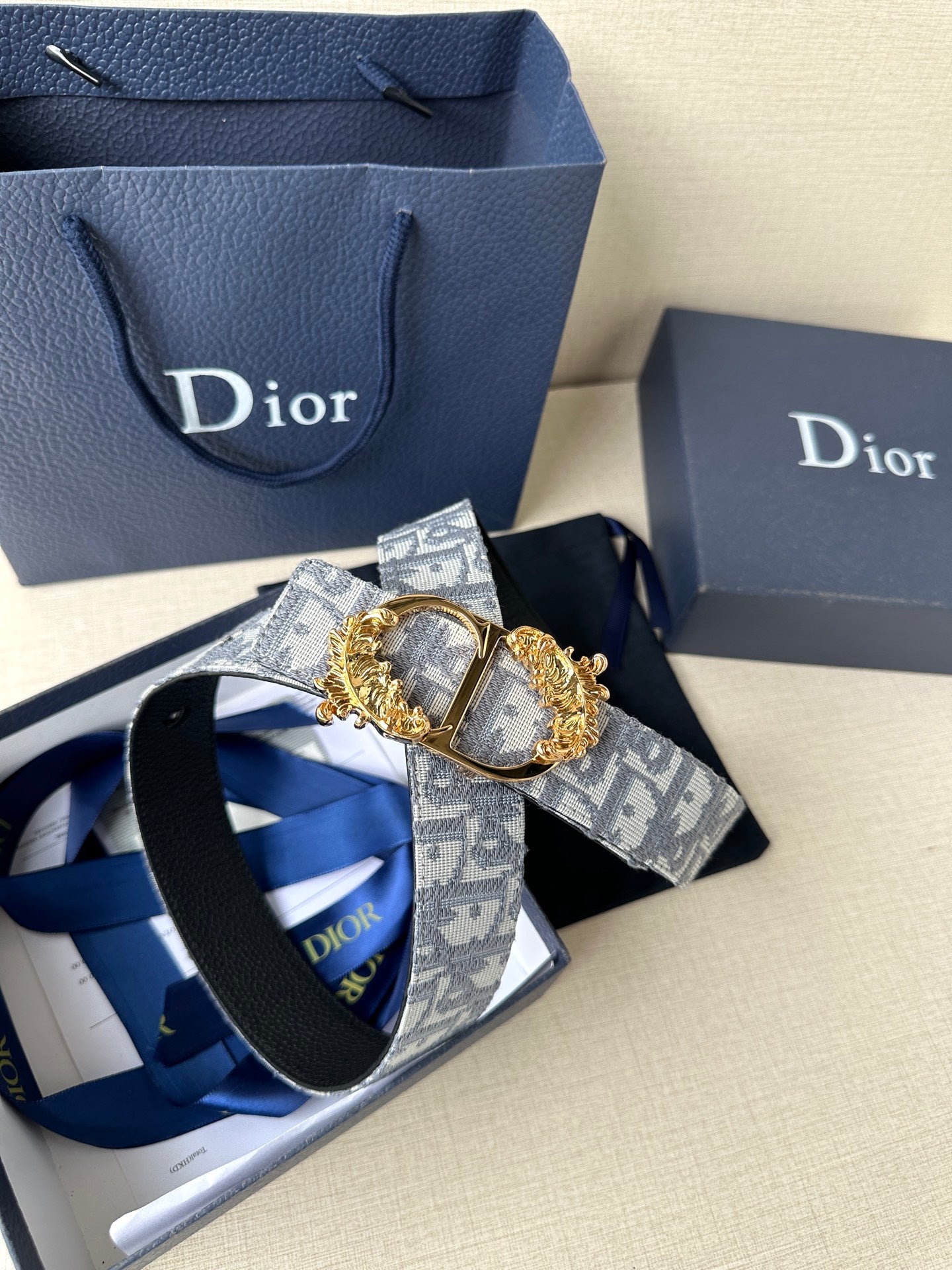 Logo jacquard belt with gold medallion buckle and dark leather understrap