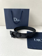 Dior belt on display with dark monogram strap and black decorative buckle