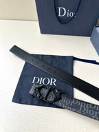 Dior belt laid flat: dark monogram strap with black buckle and embossed Dior markings