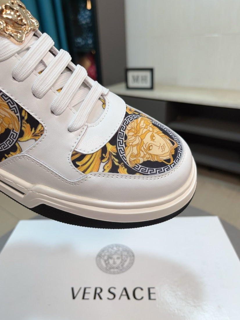 White leather sneakers with gold baroque side panel and lace-up vamp detail.