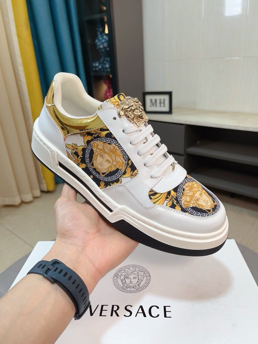 White lace-up sneakers with gold medallion print and textured gold collar accents.