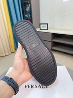 Dark rubber outsole for low-top sneakers with striped tread and brand mark on footbed.