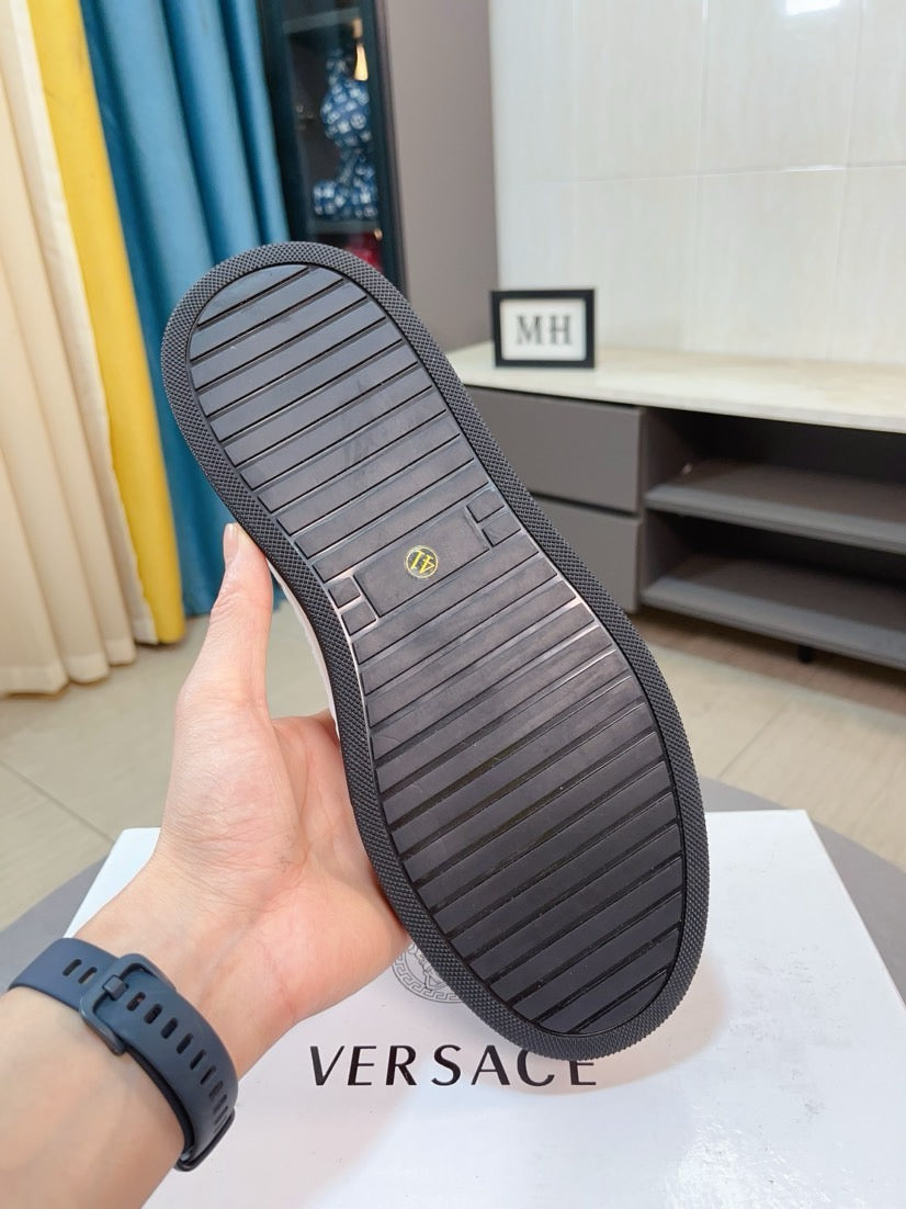 Dark rubber outsole for low-top sneakers with striped tread and brand mark on footbed.