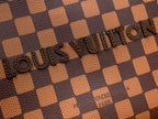 Louis Vuitton Damier checkered canvas with raised embossed logo detail