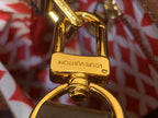 Louis Vuitton gold-tone padlock hardware with engraved brand on metal