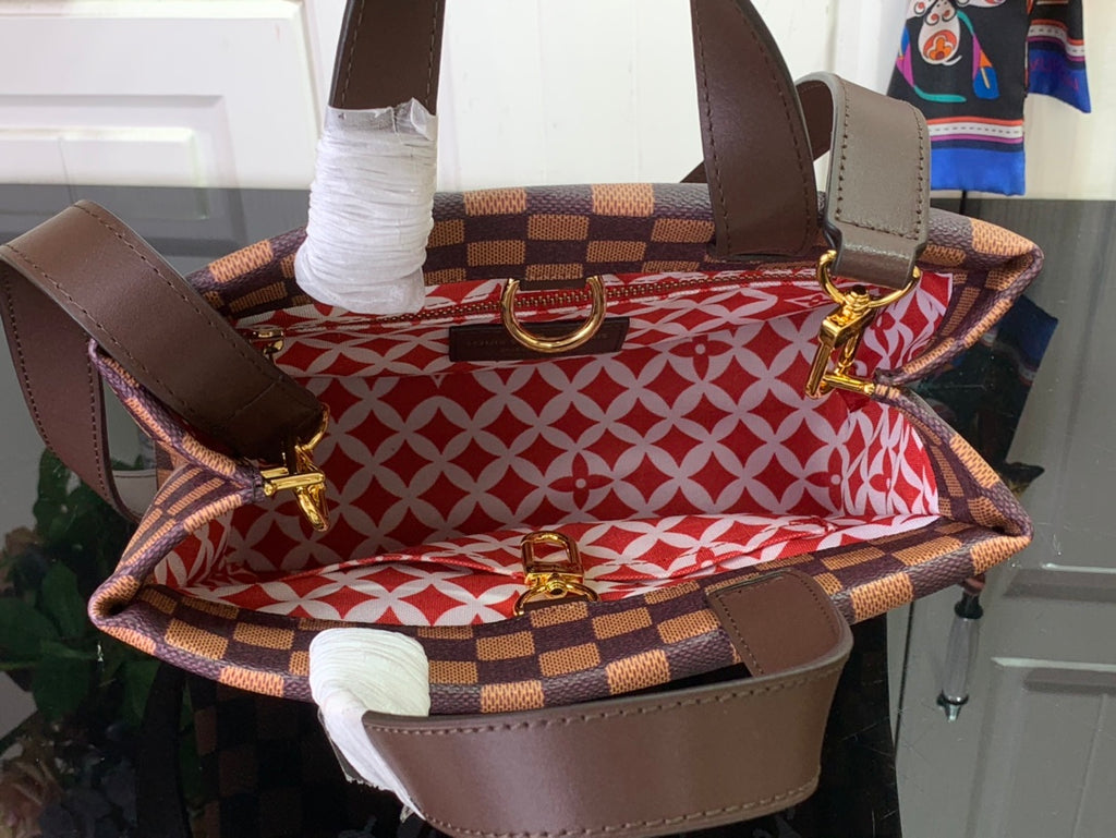 Louis Vuitton Damier checkered tote bag with red patterned interior and gold hardware
