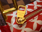 Louis Vuitton gold zipper pull clasp on red patterned fabric