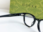Black Gucci eyeglasses close-up of hinge and temple with clear lenses