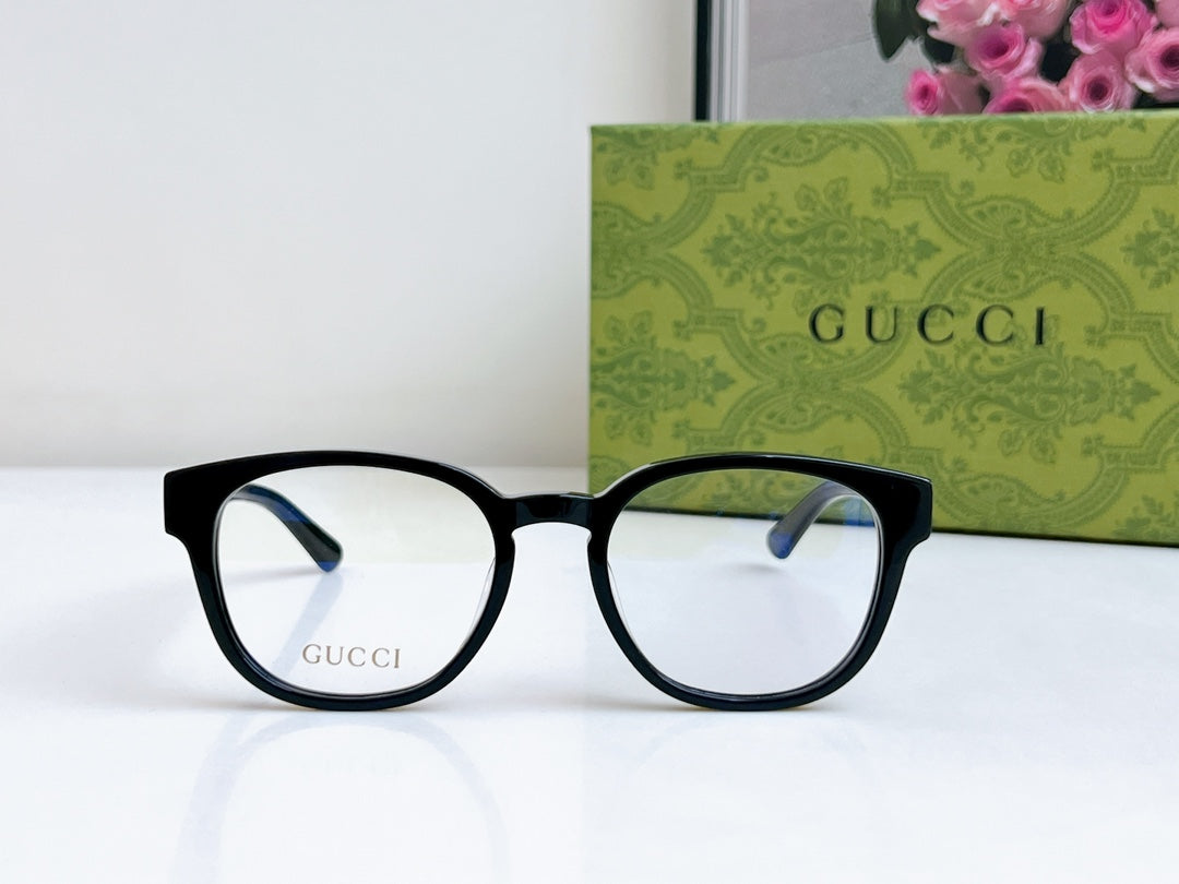 Black Gucci eyeglasses with rounded rectangular frames and clear lenses