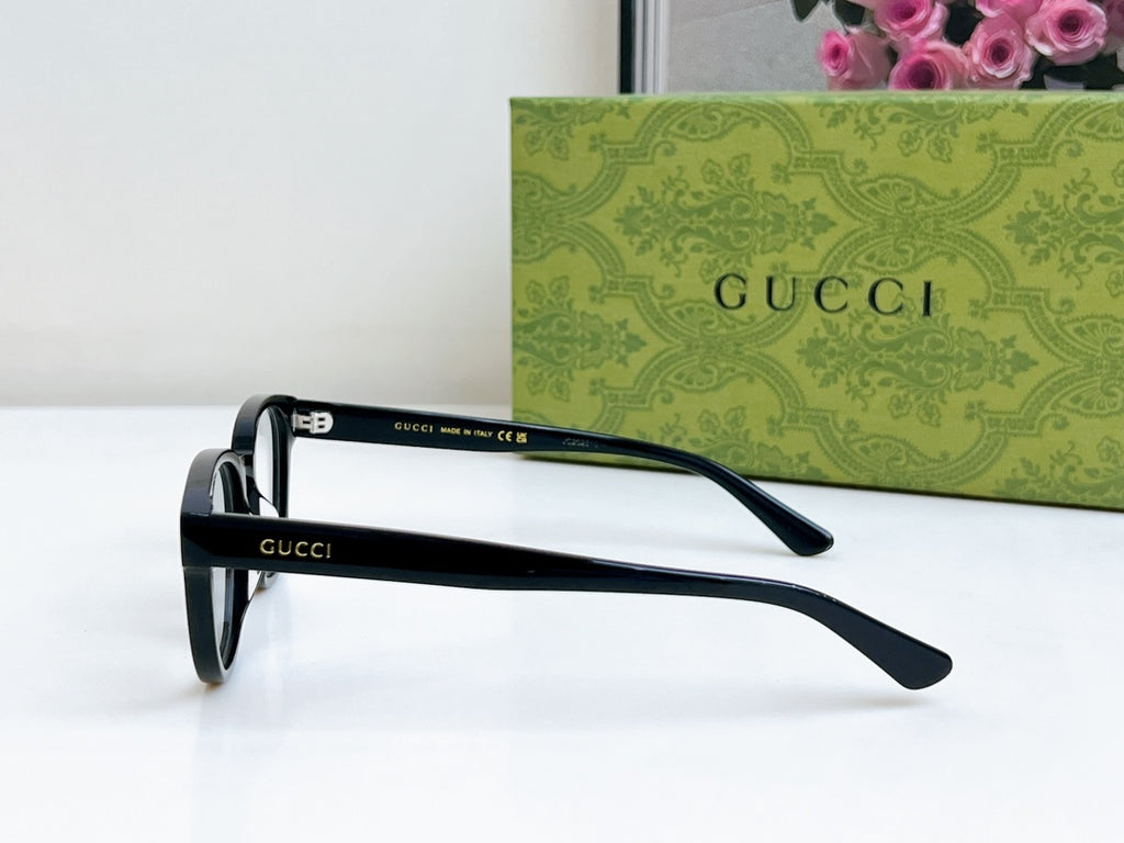Black Gucci eyeglasses with curved temple tips and clear lenses