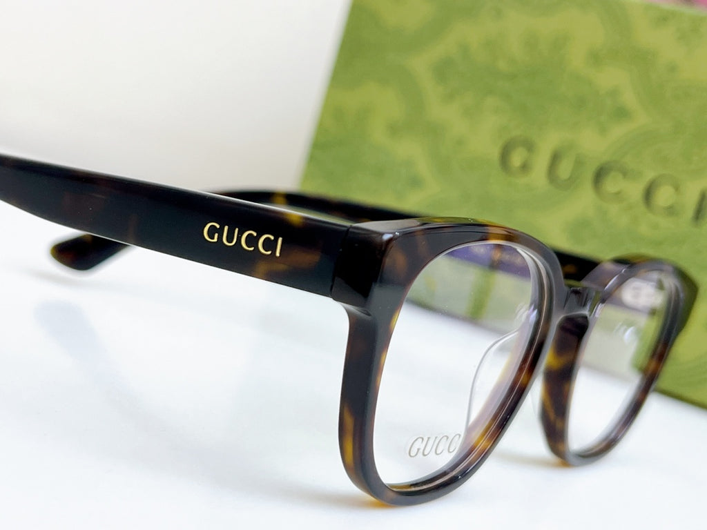 Gucci eyeglasses close-up of temple logo and front frame with blue-tinted lens