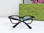 Gucci eyeglasses crossed view with tortoiseshell front and clear blue-tinted lenses