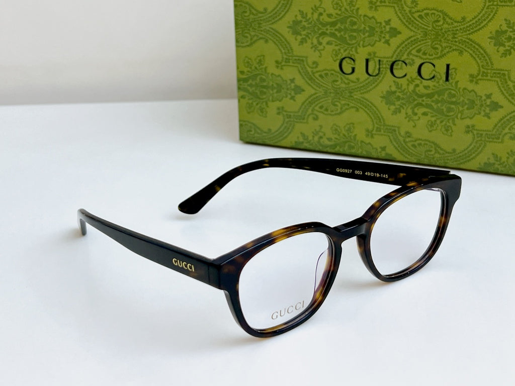 Gucci eyeglasses laid out with black and tortoiseshell frames and curved temples