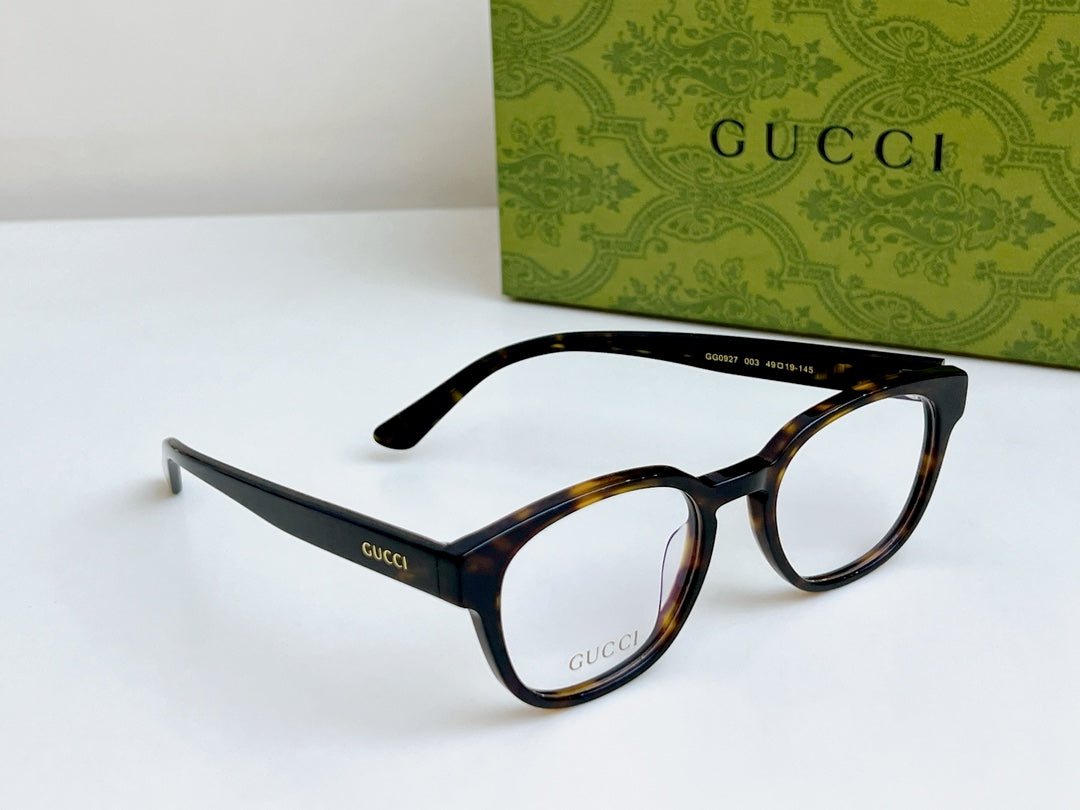 Gucci eyeglasses laid out with black and tortoiseshell frames and curved temples