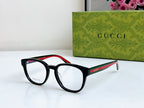 Black Gucci eyeglasses, angled side view with red-green temple stripe