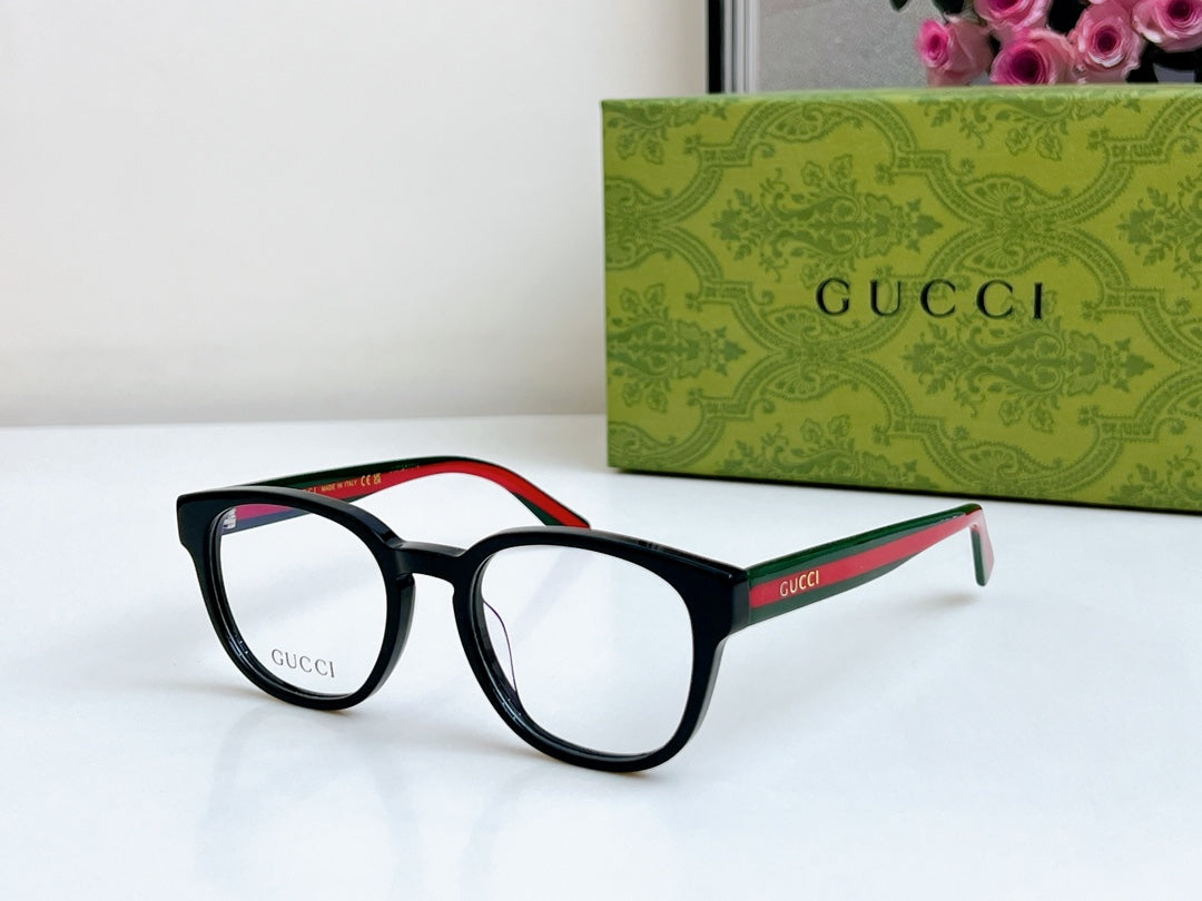 Black Gucci eyeglasses, angled side view with red-green temple stripe