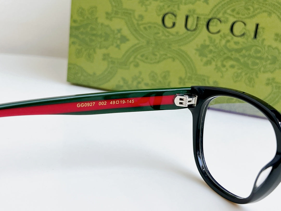 Black Gucci eyeglasses, red-green temple band with Gucci details