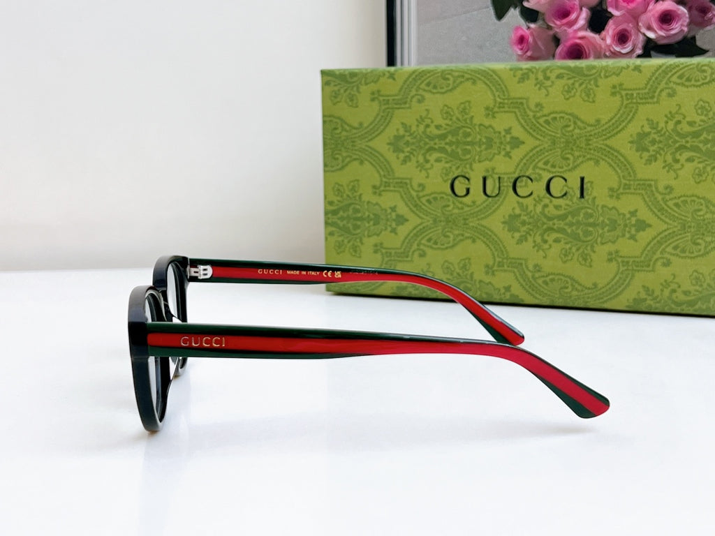 Black Gucci eyeglasses with red and green temple arms, profile view