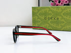 Black Gucci eyeglasses with red and green temple arms, profile view