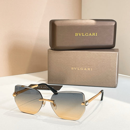 Bvlgari eyeglasses, light blue lenses, gold-tone frame, black temples.