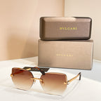 Bvlgari eyeglasses, amber gradient lenses, gold-tone frame, black temples.
