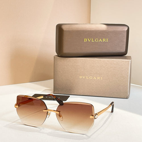 Bvlgari eyeglasses, amber gradient lenses, gold-tone frame, black temples.