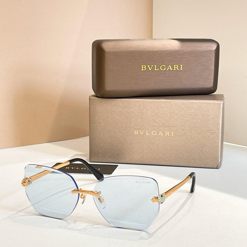 Bvlgari eyeglasses, pale blue lenses, gold-tone frame, black temples.