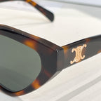 Tortoiseshell cat-eye sunglasses with dark lenses and gold-tone logo detail