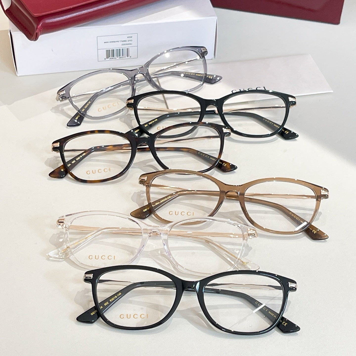 Gucci glasses: assorted round frames in black, tortoise, clear, and silver tones, with cases