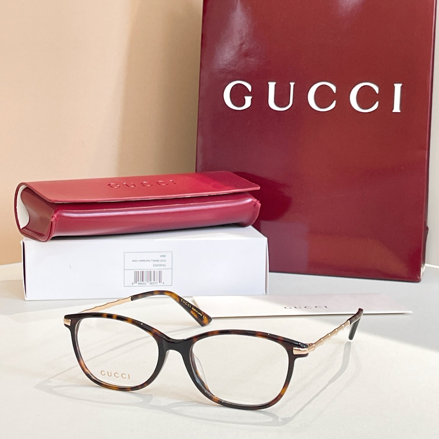 Gucci glasses: tortoise pattern round frames with gold temples, with red case and box
