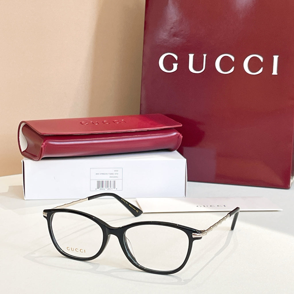 Gucci glasses: black round frames with gold logo temples, shown with red case and box