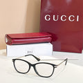 Gucci glasses: black round frames with gold logo temples, shown with red case and box