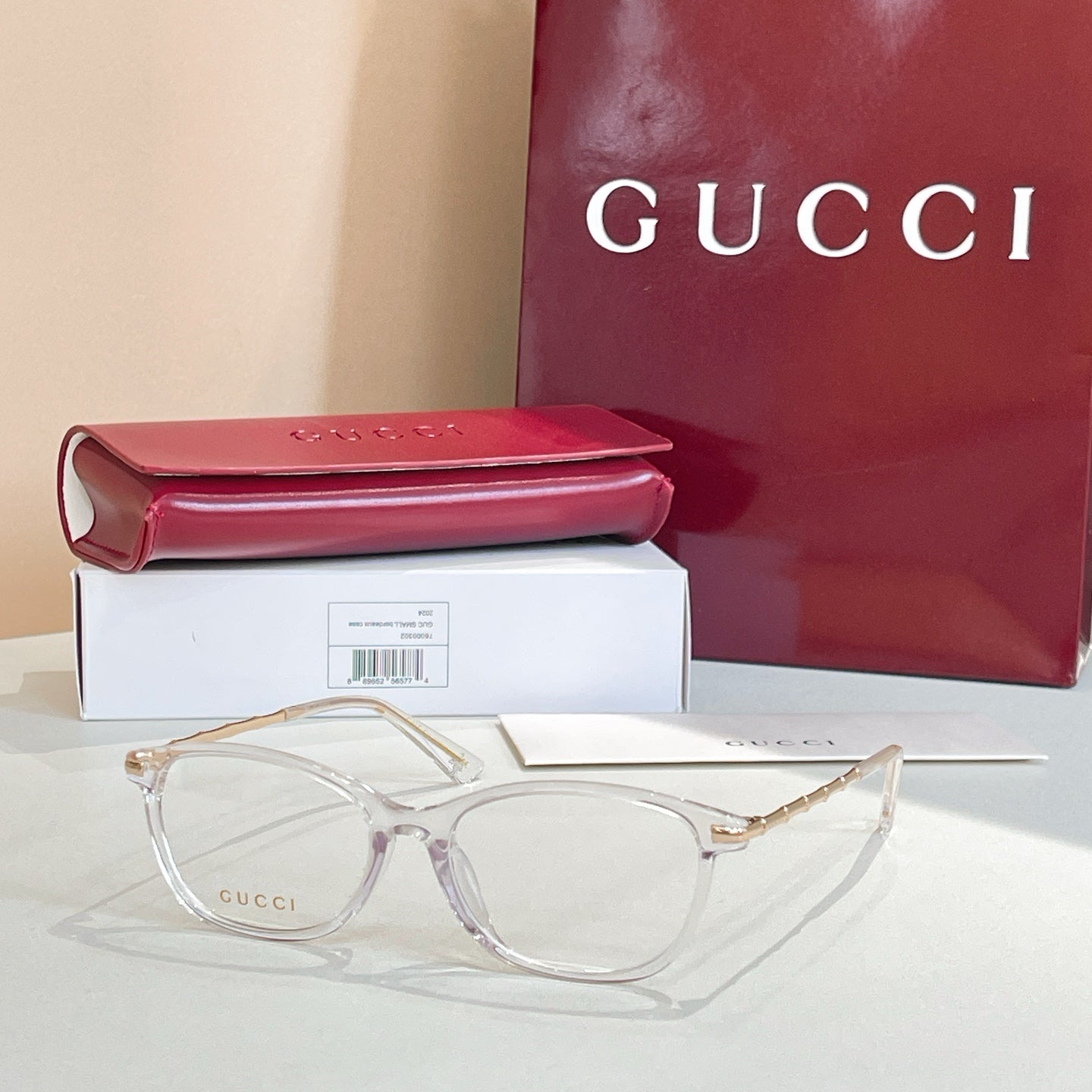 Gucci glasses: light-clear round frames with gold temples, with red case and box