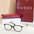 Gucci glasses: black round eyeglasses with gold metal temples, beside red case and box