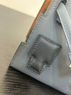 Hermes bag in light blue with textured leather and stitched decorative patch panel.