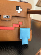 Hermes bag close-up in tan leather with red and blue geometric cross appliques