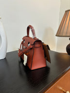 Hermes top-handle handbag, red-brown leather with side straps and white cross accents