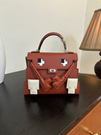 Hermes top-handle handbag with red-brown leather, white front plaques, flap closure