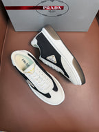 Prada unisex sneakers, white upper with black stripe detail and chunky rubber sole.