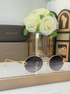 Bvlgari round sunglasses with dark lenses and gold-tone frame, multicolor jewel embellishments