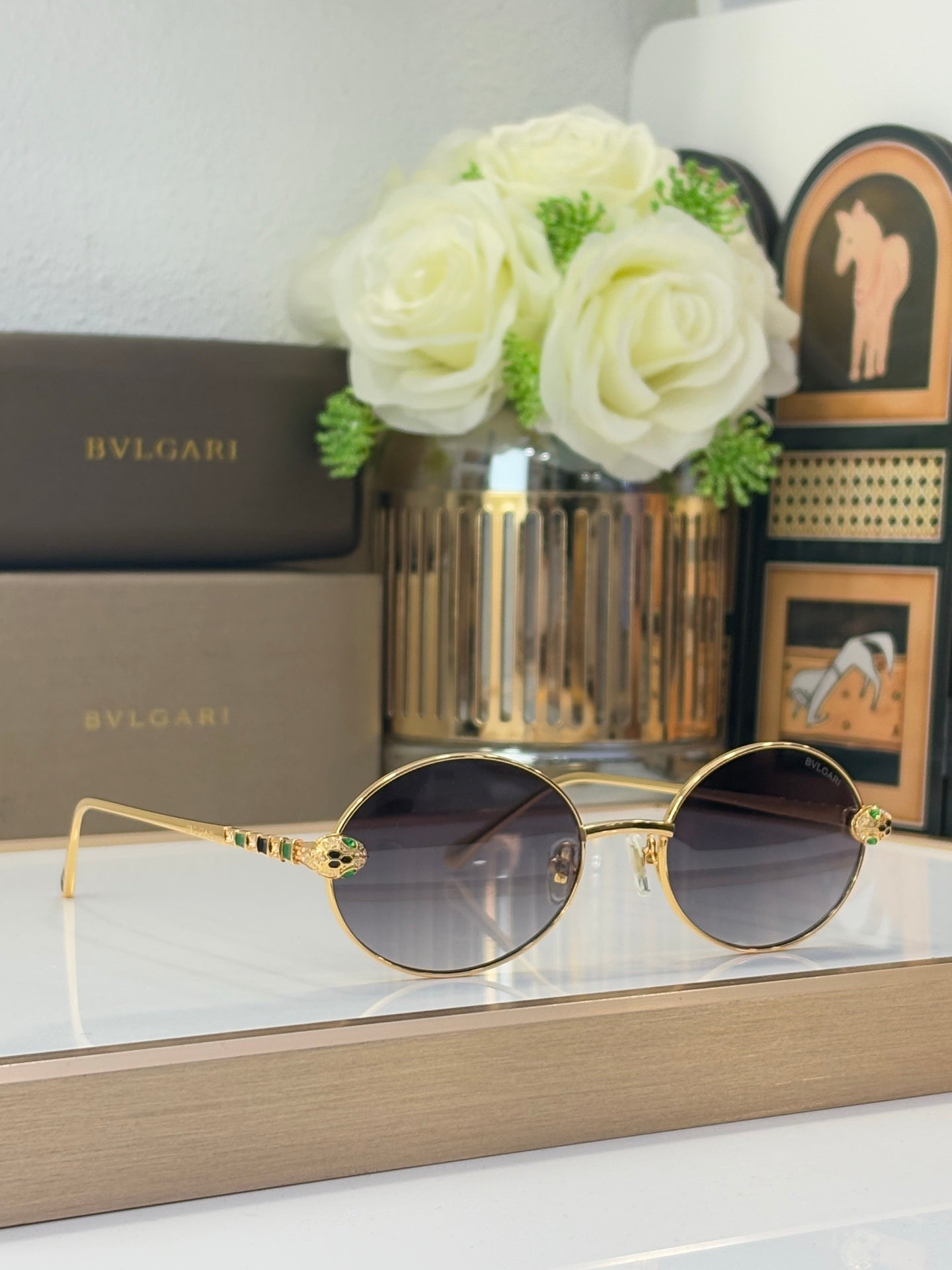 Bvlgari round sunglasses with dark lenses and gold-tone frame, multicolor jewel embellishments