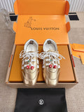 Louis Vuitton metallic gold sneakers with white laces and cherry charm on side