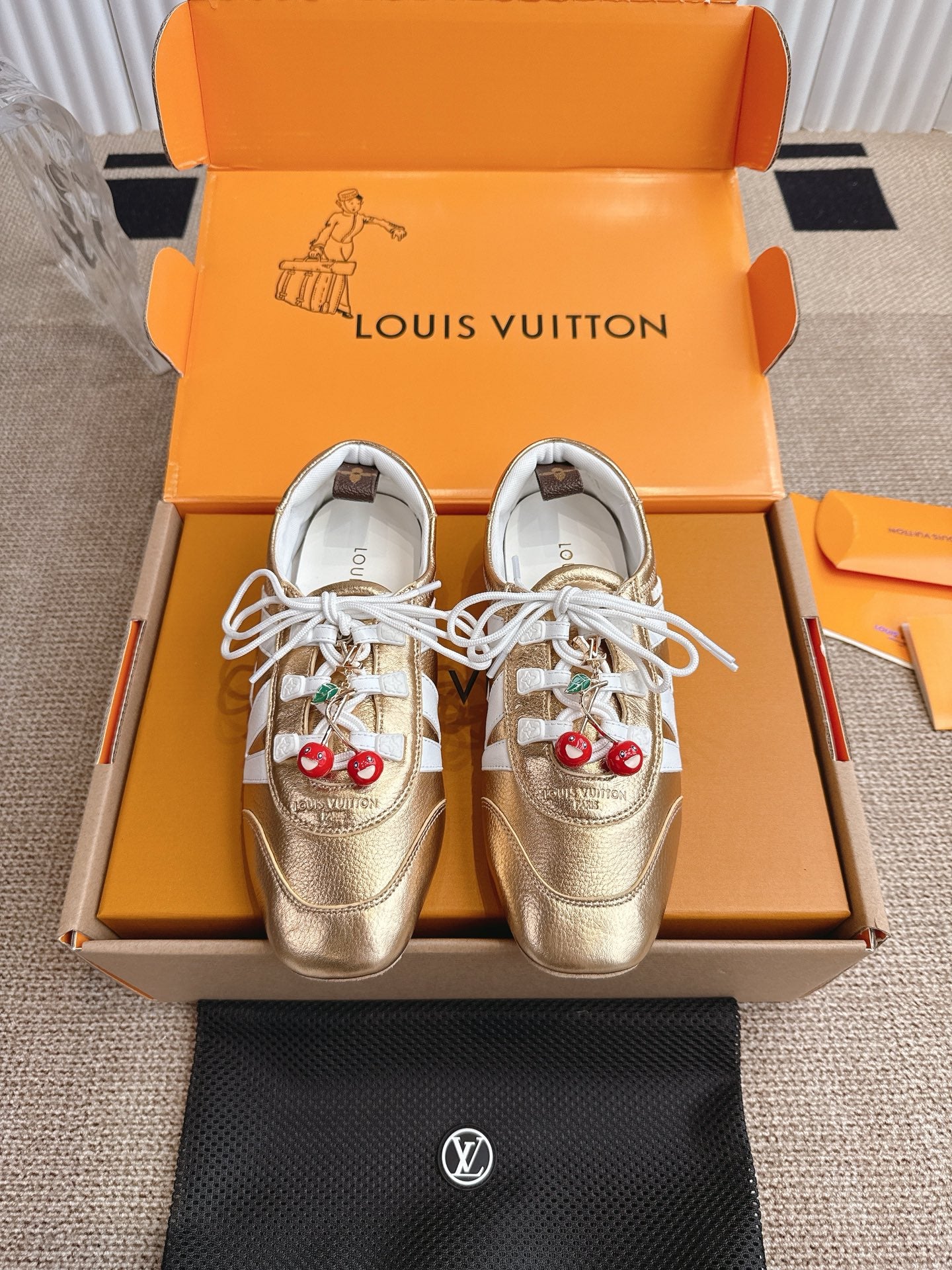 Louis Vuitton metallic gold sneakers with white laces and cherry charm on side