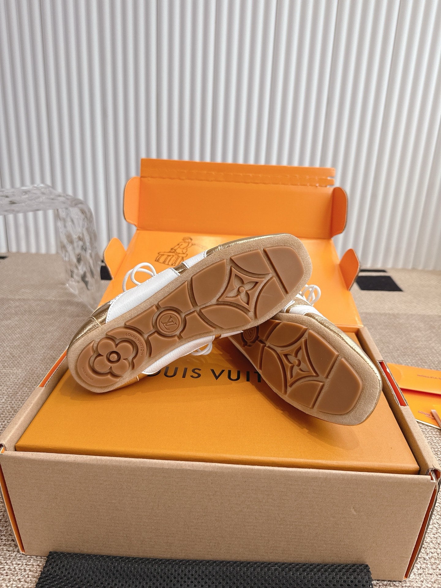 Louis Vuitton sneakers outsole detail with textured pattern on metallic gold pair