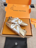 Louis Vuitton metallic gold sneakers with white laces and contrasting white toe panels