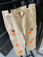 Light khaki denim pants with front patch graphics and slanted side pockets