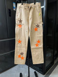 Light khaki pants with orange star patches and leopard-style star applique
