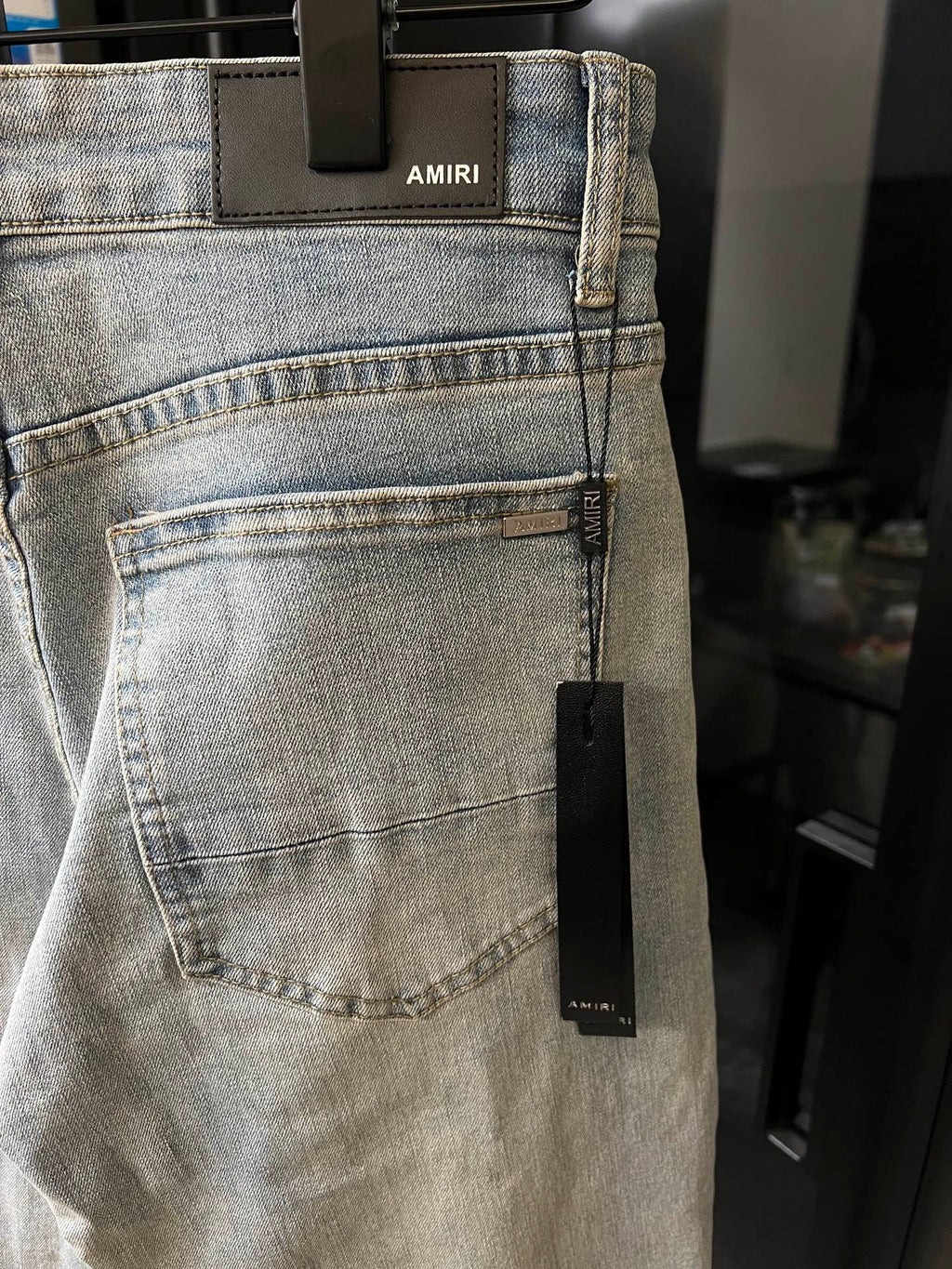 Light-wash denim jeans with front pocket and woven care label near the side seam