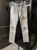 Amiri light-wash jeans with ripped knee patches and distressed hems